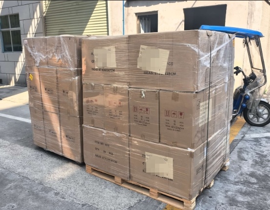glassware cartons shrink-wrapped on the export pallet before loading
