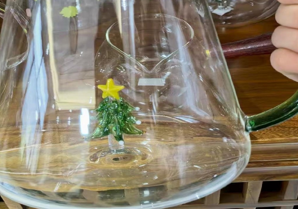 star-topped glass tree figure fused to the inside base of a borosilicate glass pitcher