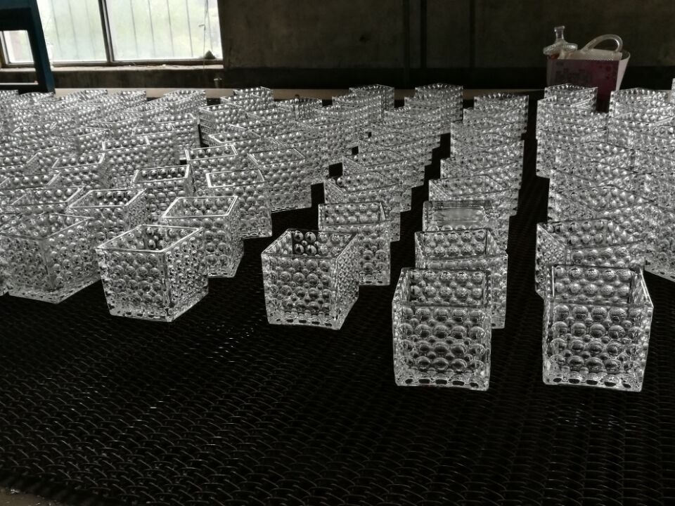 glass vase manufacturer - square textured glass vases lined up on the production table