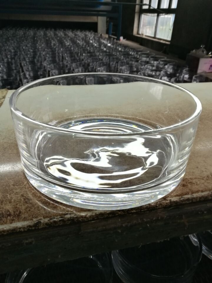 glass vase manufacturer - shallow round glass vase close up with rows behind