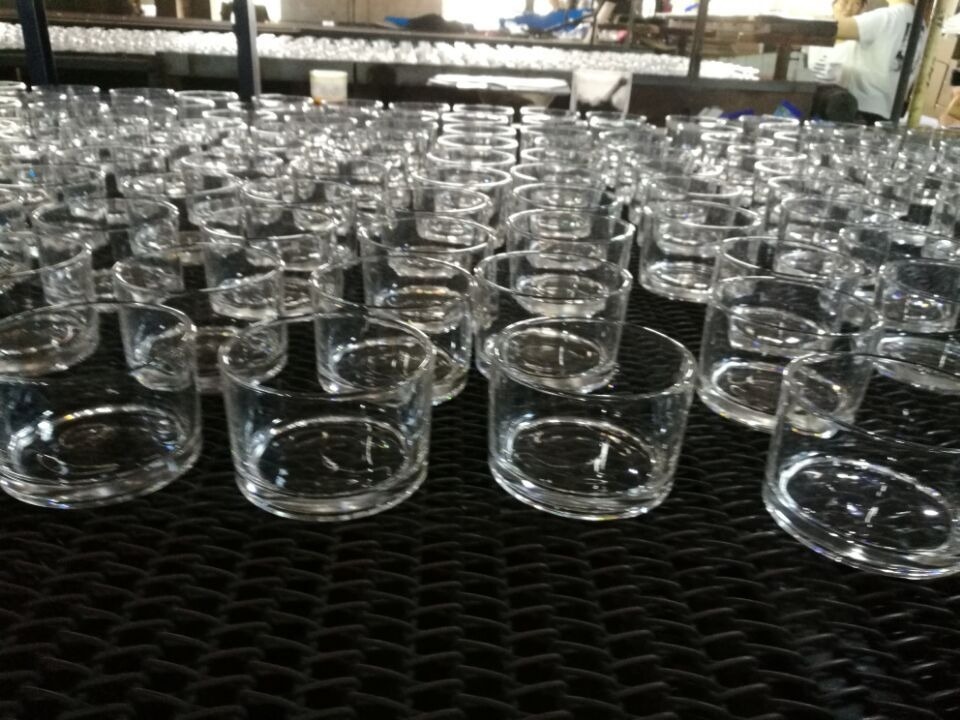 glass vase manufacturer - small glass vases lined up across the workshop line